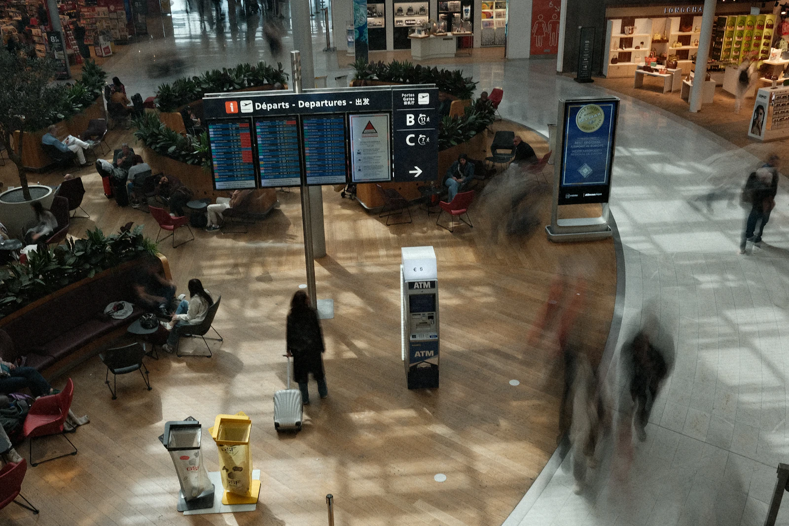 Airport departure boards in a busy terminal