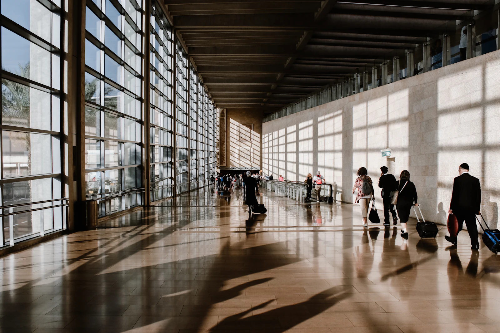 Passengers walking through a bright airport terminal