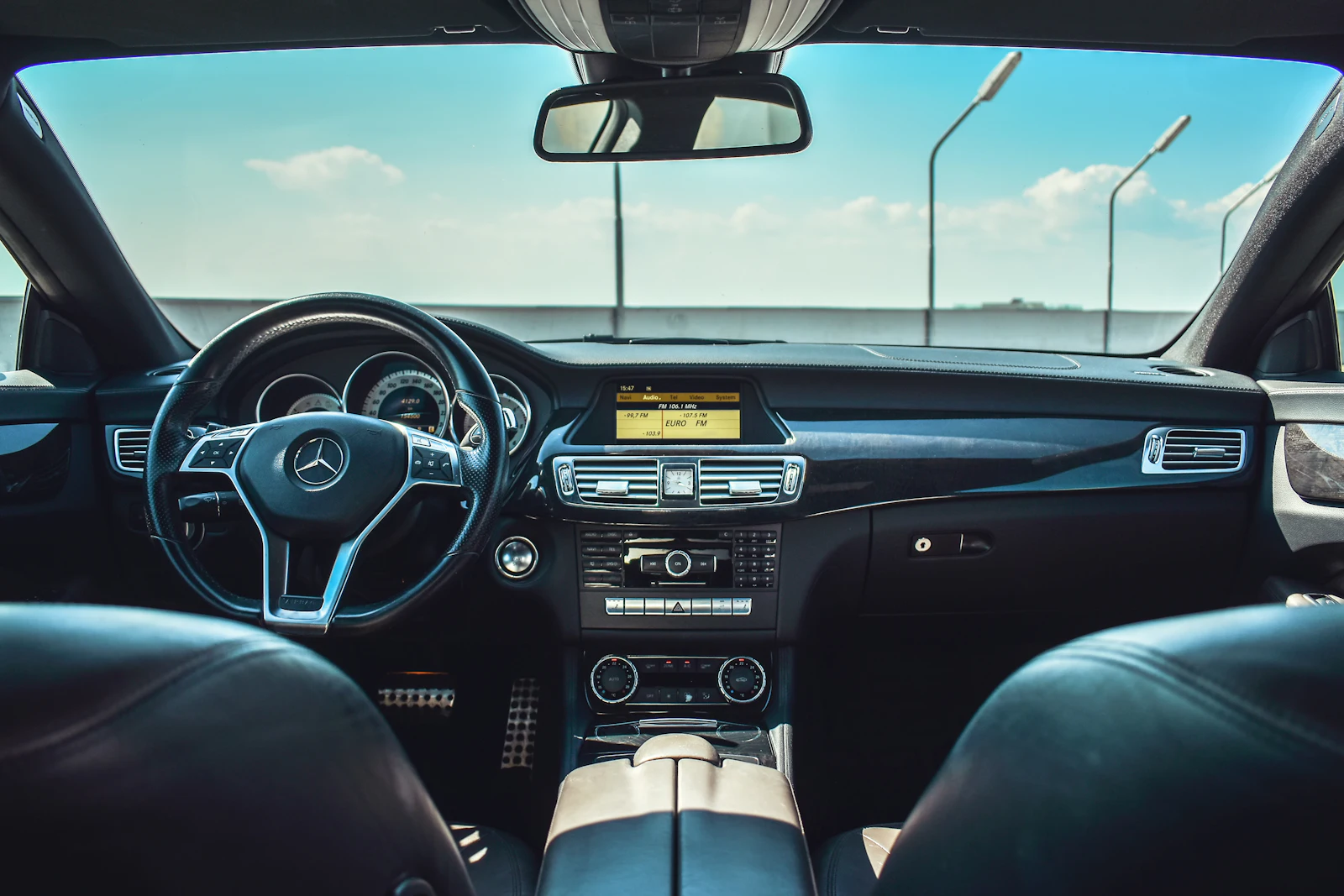 Executive car interior with leather steering wheel